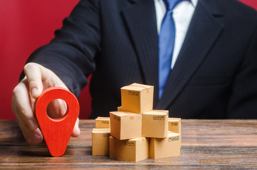 a businessman sets a destination for delivery of goods. distribution, freight transportation shipment. logistics and warehousing. global market and business, import and export. trade in new markets.