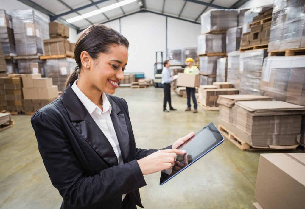 female manager using digital tablet in warehouse