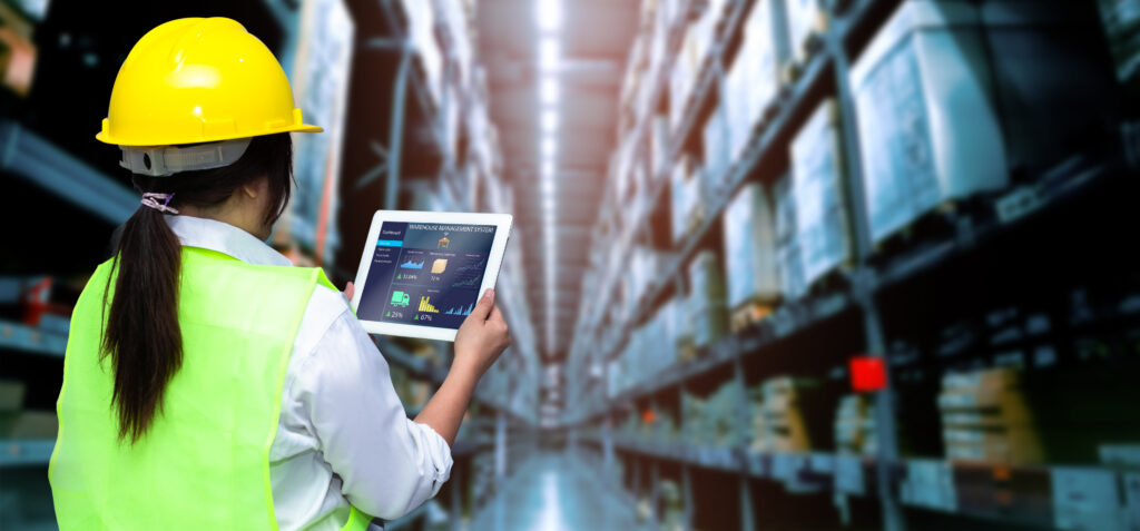 smart warehouse management systemworker hands holding tablet blurred warehouse as background