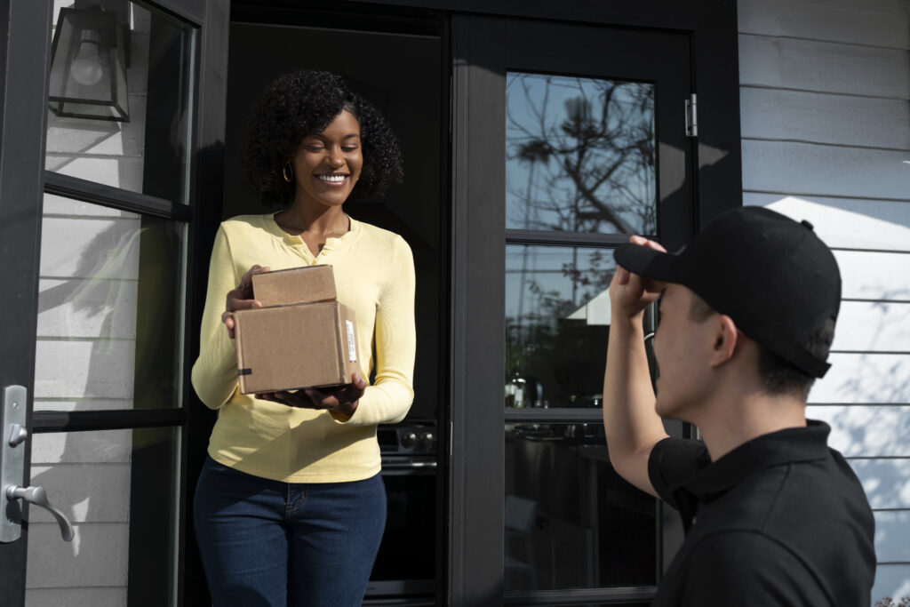 delivery person getting parcel out delivery