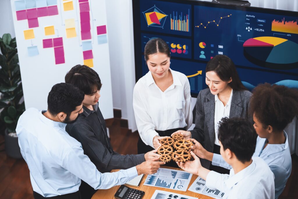 office worker holding cog wheel as unity and teamwork in workplace. concord